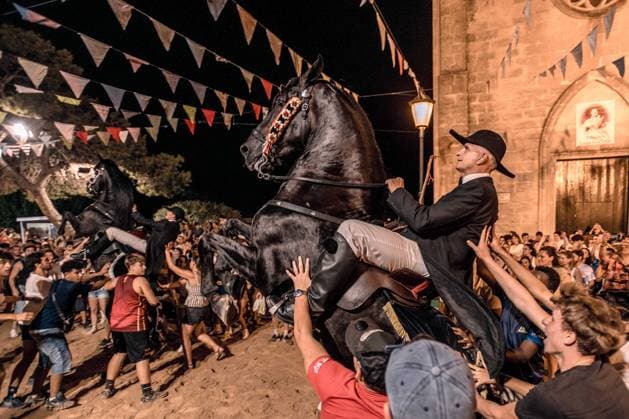 August 8, 2026, Llucmacanes, Menorca Balearic Islands, Spain: A caixer, or horse rider, rears his horse amid a cheering crowd during the traditional Jaleo at the Sant Gaieta Festival in Llucmacanes Llucmacanes Spain - ZUMAo105 20260808_fap_o105_010 Copyright: xMatthiasxOesterlex