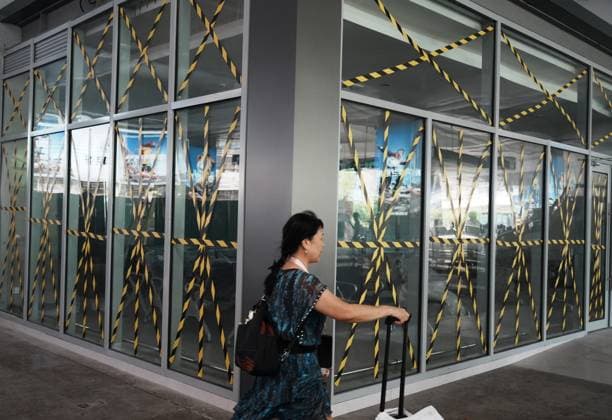 HANGZHOU, CHINA - AUGUST 09: Tape is applied in a cross pattern to windows at a temporary waiting room of Hangzhou Railway Station to prepare for Typhoon Dolphin on August 9, 2026 in Hangzhou, Zhejiang Province of China.  Copyright: xVCGx 111658929011