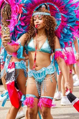 August 8, 2026, Edmonton, Alberta, Canada: Mas Band member stops for a selfie as she dances through downtown Edmonton during the Cariwest Parade on day 2 of the Cariwest Festival..Western Canada s largest Caribbean Festival, Cariwest, held its annual parade as part of its 42nd year of festivities. The Parade Mas Bands represent the various Caribbean various Islands and are dressed in brightly colored costumes, some of which can weigh up to 200 lbs, requiring wheels to support the weight. Edmonton Canada - ZUMAs197 20260808_aaa_s197_224 Copyright: xRonxPalmerx