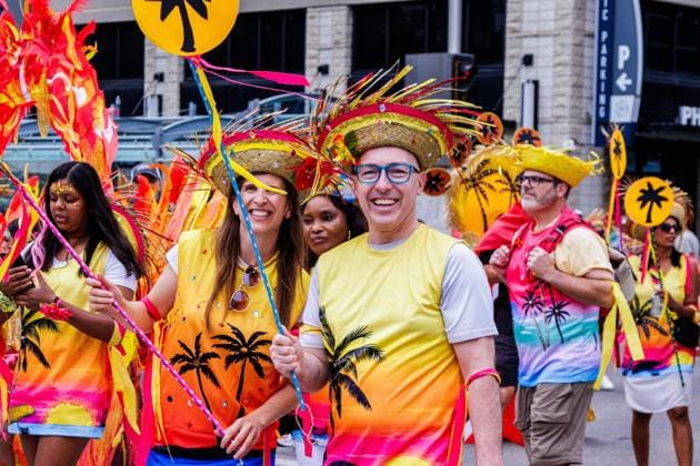 August 8, 2026, Edmonton, Alberta, Canada: City Councillor Anne Stevenson and Edmonton Mayor Andrew Knack joined one of the Mas Bands dancing through downtown Edmonton during the Cariwest Parade on day 2 of the Cariwest Festival..Western Canada s largest Caribbean Festival, Cariwest, held its annual parade as part of its 42nd year of festivities. The Parade Mas Bands represent the various Caribbean various Islands and are dressed in brightly colored costumes, some of which can weigh up to 200 lbs, requiring wheels to support the weight. Edmonton Canada - ZUMAs197 20260808_aaa_s197_239 Copyright: xRonxPalmerx