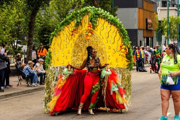 August 8, 2026, Edmonton, Alberta, Canada: Mas Band members pull their costumes weighing up to 200 lbs through downtown Edmonton during the Cariwest Parade on day 2 of the Cariwest Festival..Western Canada s largest Caribbean Festival, Cariwest, held its annual parade as part of its 42nd year of festivities. The Parade Mas Bands represent the various Caribbean various Islands and are dressed in brightly colored costumes, some of which can weigh up to 200 lbs, requiring wheels to support the weight. Edmonton Canada - ZUMAs197 20260808_aaa_s197_243 Copyright: xRonxPalmerx