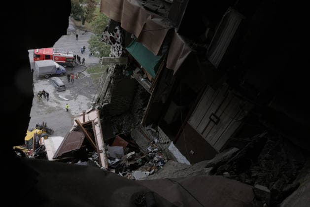 Russian Drone Strike On Residential Building - Kharkiv Rescue workers and emergency personnel search through debris and rubble at a multi-story residential building that was struck by a drone, with heavy equipment and fire trucks positioned nearby in Kharkiv, Ukraine, on August 9, 2026. The attack destroyed multiple floors of the building in the Saltivka district, killing two people and wounding dozens of residents, according to local authorities. Rescue operations continued through the morning as crews worked to locate survivors trapped beneath the collapsed structure. Photo by Yevhen Titov ABACAPRESS.COM Kharkiv Kharkiv Oblast Ukraine  Copyright: xTitovxYevhen ABACAx