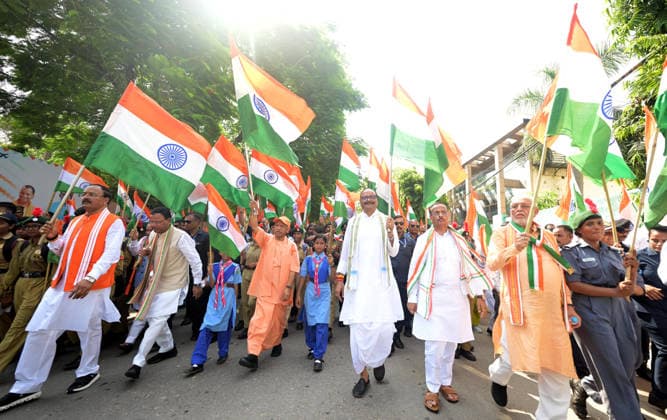 LUCKNOW, INDIA - AUGUST 9: Uttar Pradesh Chief Minister Yogi Adityanath along with deputy CM Keshav Prasad Maurya and deputy CM Brajesh Pathak and BJP state President Pankaj Chaudhary waves national flag during Tiranga Yatra under the Har Ghar Tiranga campaign ahead of the 80th Independence Day on August 9, 2026 in Lucknow, India. (Photo by Deepak Gupta Hindustan Times) UP CM Yogi Adityanath Leads Tiranga Yatra Under Har Ghar Tiranga Campaign Ahead Independence Day