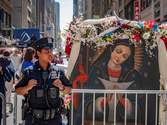 August 9, 2026, New York, New York, USA: A New York City police officer stands along the route of the 44th annual Dominican Day Parade on Sixth Avenue in New York. Held under the theme Identity and Culture, the parade featured colorful floats, traditional dance groups, and merengue and bachata music as thousands of participants and spectators celebrated Dominican heritage. New York USA - ZUMAh156 20260809_znp_h156_021 Copyright: xMiloxHessx