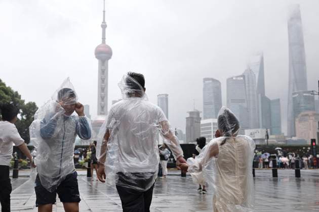 SHANGHAI, CHINA - AUGUST 09: Tourists wearing raincoats walk in the rain along the Bund on August 9, 2026 in Shanghai, China. The Shanghai Meteorological Observatory upgraded the rainstorm warning signal for the central urban area from orange to red at 10:30 a.m. due to the impact of Typhoon Dolphin.  Copyright: xChinaxNewsxServicex 111658975486