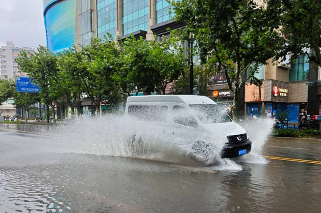 SHANGHAI, CHINA - AUGUST 09: Vehicles drive through deep floodwaters on Lingling Road as Typhoon Dolphin brings heavy rainfall and strong winds to the city on August 9, 2026 in Shanghai, China.  Copyright: xVCGx 111659005856