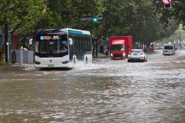 SHANGHAI, CHINA - AUGUST 09: Vehicles move slowly through deep floodwater on Lingling Road as heavy rain brought by Typhoon Dolphin hits the city on August 9, 2026 in Shanghai, China. Typhoon Dolphin has caused widespread flooding and strong winds across the region.  Copyright: xVCGx 111659005857