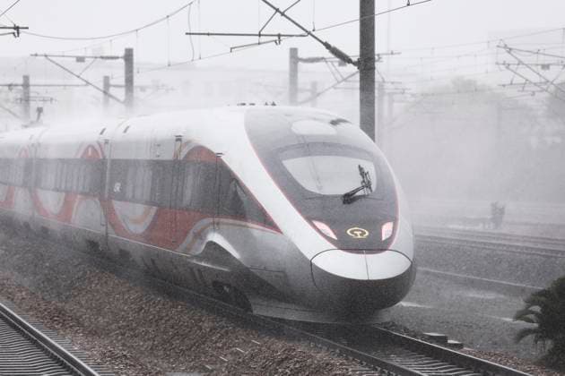 SHANGHAI, CHINA - AUGUST 09: A high-speed train operates during heavy rain caused by Typhoon Dolphin on August 9, 2026 in Shanghai, China. China s national observatory on August 9 activated a red alert -- the highest level in the country s typhoon warning system -- as Typhoon Dolphin approaches.  Copyright: xChinaxNewsxServicex 111658973292