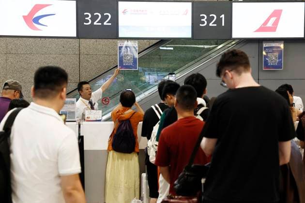 SHANGHAI, CHINA - AUGUST 09: A passenger scans QR code to obtain a delay certificate at the Terminal 2 of Shanghai Hongqiao International Airport on August 9, 2026 in Shanghai, China. Nearly 60 percent of flights were adjusted or canceled at Shanghai Pudong and Hongqiao international airports due to Typhoon Dolphin, the 13th typhoon of the year, with a total of 1,384 flights canceled across both hubs.  Copyright: xChinaxNewsxServicex 111658970321