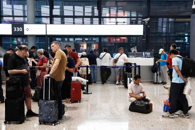 SHANGHAI, CHINA - AUGUST 09: Passengers handle ticket changes and refunds at the Terminal 2 of Shanghai Hongqiao International Airport on August 9, 2026 in Shanghai, China. Nearly 60 percent of flights were adjusted or canceled at Shanghai Pudong and Hongqiao international airports due to Typhoon Dolphin, the 13th typhoon of the year, with a total of 1,384 flights canceled across both hubs.  Copyright: xChinaxNewsxServicex 111658970327