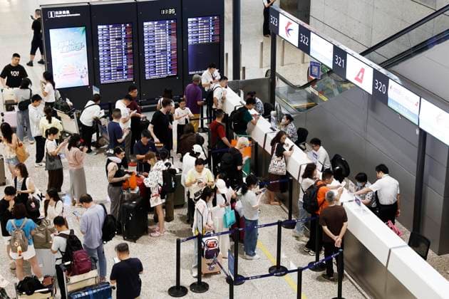 SHANGHAI, CHINA - AUGUST 09: Passengers handle ticket refunds and changes at the Terminal 2 of Shanghai Hongqiao International Airport on August 9, 2026 in Shanghai, China. Nearly 60 percent of flights were adjusted or canceled at Shanghai Pudong and Hongqiao international airports due to Typhoon Dolphin, the 13th typhoon of the year, with a total of 1,384 flights canceled across both hubs.  Copyright: xChinaxNewsxServicex 111658970387