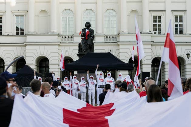 August 9, 2026, Warsaw, Poland: Members of the Volny Chor, whose identities are concealed for security reasons, perform during an evening rally marking the sixth anniversary of the August 2020 presidential election in Belarus. An evening gathering marking the sixth anniversary of the August 2020 presidential election in Belarus was held near the Nicolaus Copernicus Monument in central Warsaw, bringing together leaders of Belarusian democratic forces, public figures and activists, as well as several hundred participants. Warsaw Poland - ZUMAs197 20260809_aaa_s197_109 Copyright: xVolhaxShukailax