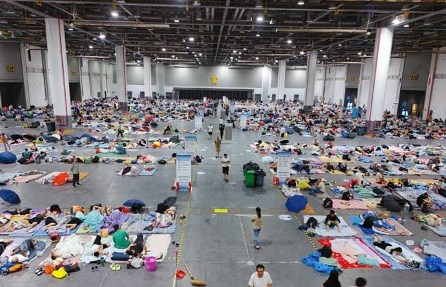 HANGZHOU, CHINA - AUGUST 09: A temporary shelter is set up for workers at Qianjiang Century City on August 9, 2026 in Hangzhou, Zhejiang Province of China. Nearly 10,000 workers were safely evacuated from the area as Typhoon Dolphin approaches.  Copyright: xVCGx 111658990985