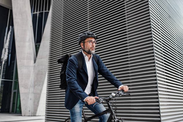 Businessman in front of office building, holding tablet and reading something. Businessman in front of modern office building, holding tablet and reading something. model released