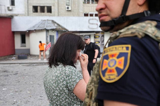 A woman wipes away tears during a response effort to a Russian S8000 Banderol cruise missile strike on a 10-storey apartment block in the Saltivskyi district, Kharkiv, Ukraine, August 9, 2026. As a result of the terrorist attack, the seventh to tenth floors were destroyed. At present, three people are confirmed dead and 37 others injured. (Photo by Viacheslav Madiievskyi Ukrinform) Russian Banderol missile strikes apartment block in Kharkiv  Copyright: xViacheslavxMadiievskyix