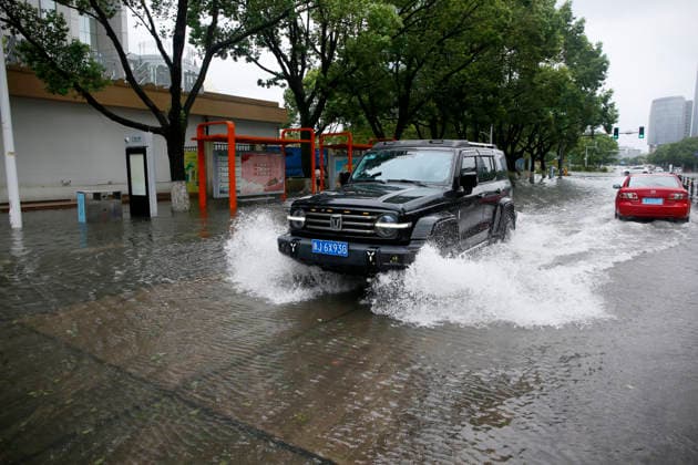 WENLING, CHINA - AUGUST 10: A vehicle drives through flooded street on August 10, 2026 in Wenling, Zhejiang Province of China. Heavy rainfall brought by Typhoon Dolphin caused severe waterlogging on roads and affecting residents travel. Typhoon Dolphin, the 13th typhoon of the year, made landfall at Yuhuan of Taizhou City, east China s Zhejiang Province, at around 5:30 p.m. on August 9.  Copyright: xVCGx 111659097423