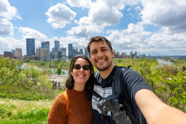 Happy couple smiling while taking a selfie with Calgary skyline Calgary, Alberta, Canada CR_UGOUSD260806-2095754-01 ,model released, Symbolfoto ,property released
