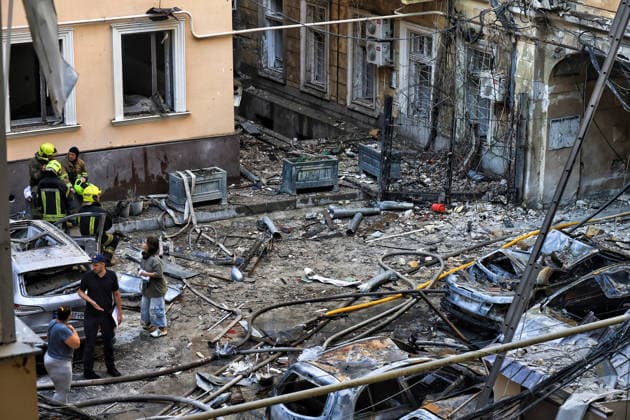 State Emergency Service workers deal with the aftermath of a Russian strike in the courtyard of a multi-storey apartment block, Odesa, Ukraine, August 9, 2026. On Sunday night, August 9, the Russian army carried out a massive combined attack on Odesa, causing significant destruction in two districts of the southern Ukrainian port city. In central Odesa, a Russian missile hit a four-storey residential building, where two floors were completely burnt out. Two private houses and offices were also damaged. At least six civilian cars were destroyed or badly damaged in courtyards by falling debris and direct hits. Damage to energy facilities led to a temporary blackout, with partial power outages in the Peresypskyi (Poskot), Prymorskyi, Khadzhybe  Copyright: xNinaxLiashonokx