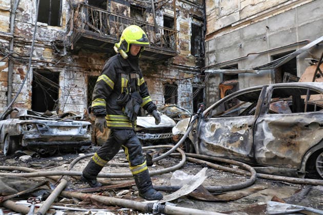 A State Emergency Service worker walks across the courtyard of a multi-storey apartment block damaged by a Russian attack, Odesa, Ukraine, August 9, 2026. On Sunday night, August 9, the Russian army carried out a massive combined attack on Odesa, causing significant destruction in two districts of the southern Ukrainian port city. In central Odesa, a Russian missile hit a four-storey residential building, where two floors were completely burnt out. Two private houses and offices were also damaged. At least six civilian cars were destroyed or badly damaged in courtyards by falling debris and direct hits. Damage to energy facilities led to a temporary blackout, with partial power outages in the Peresypskyi (Poskot), Prymorskyi, Khadzhybeiskyi  Copyright: xNinaxLiashonokx