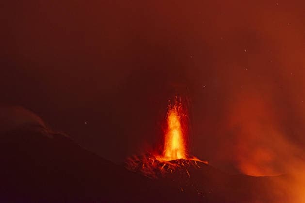 Mount Etna s eruptive phase persists CATANIA, ITALY - AUGUST 10: Mount Etna s eruptive phase persists with fluctuating explosive dynamics at the Voragine summit crater in Catania, Sicily, Italy on August 10, 2026. The ongoing unrest is marked by the ejection of volcanic bombs in the upper peak area and heavy ash plumes. Additionally, the fissures situated at elevations of 2,750 and 2,360 meters continue to actively discharge magma, creating intricate and overlapping lava streams currently restricted between 2,100 and 1,850 meters. A thick cloud of volcanic debris is drifting south-southeast, causing officials to uphold a red aviation warning. The persistent airborne ash compelled airport authorities to temporarily halt all inbound flights a  Copyright: x2026xAnadoluxSalvatorexAllegrax