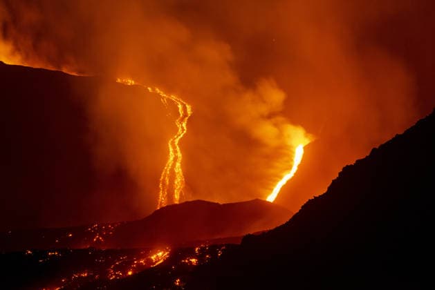 Mount Etna s eruptive phase persists CATANIA, ITALY - AUGUST 10: Mount Etna s eruptive phase persists with fluctuating explosive dynamics at the Voragine summit crater in Catania, Sicily, Italy on August 10, 2026. The ongoing unrest is marked by the ejection of volcanic bombs in the upper peak area and heavy ash plumes. Additionally, the fissures situated at elevations of 2,750 and 2,360 meters continue to actively discharge magma, creating intricate and overlapping lava streams currently restricted between 2,100 and 1,850 meters. A thick cloud of volcanic debris is drifting south-southeast, causing officials to uphold a red aviation warning. The persistent airborne ash compelled airport authorities to temporarily halt all inbound flights a  Copyright: x2026xAnadoluxSalvatorexAllegrax