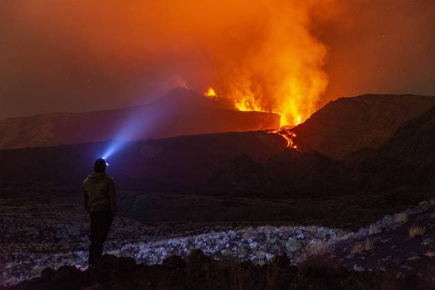 Mount Etna s eruptive phase persists CATANIA, ITALY - AUGUST 10: Mount Etna s eruptive phase persists with fluctuating explosive dynamics at the Voragine summit crater in Catania, Sicily, Italy on August 10, 2026. The ongoing unrest is marked by the ejection of volcanic bombs in the upper peak area and heavy ash plumes. Additionally, the fissures situated at elevations of 2,750 and 2,360 meters continue to actively discharge magma, creating intricate and overlapping lava streams currently restricted between 2,100 and 1,850 meters. A thick cloud of volcanic debris is drifting south-southeast, causing officials to uphold a red aviation warning. The persistent airborne ash compelled airport authorities to temporarily halt all inbound flights a  Copyright: x2026xAnadoluxSalvatorexAllegrax