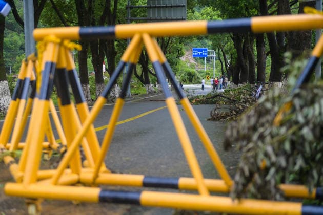 (260810) -- WENZHOU, Aug. 10, 2026 -- A road is closed due to fallen trees and flooding caused by Typhoon Dolphin in Huling Town, Wenzhou, east China s Zhejiang Province, Aug. 10, 2026. Typhoon Dolphin is moving inland after making two landfalls along the coast of east China s Zhejiang Province and is expected to bring heavy precipitation to more than 10 provincial-level regions, according to China s National Meteorological Center on Monday. ) CHINA-ZHEJIANG-WENZHOU-TYPHOON DOLPHIN-IMPACT (CN) JiangxHan 