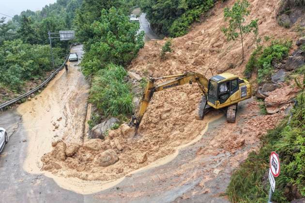 (260810) -- WENZHOU, Aug. 10, 2026 -- A drone photo taken on Aug. 10, 2026 shows a staff member operating an excavator to clear the collapsed section of a road in Luojialiao Village in Wenzhou, east China s Zhejiang Province. Typhoon Dolphin is moving inland after making two landfalls along the coast of east China s Zhejiang Province and is expected to bring heavy precipitation to more than 10 provincial-level regions, according to China s National Meteorological Center on Monday. (Photo by Xinhua) CHINA-ZHEJIANG-WENZHOU-TYPHOON DOLPHIN-IMPACT (CN) SuxQiaojiang 