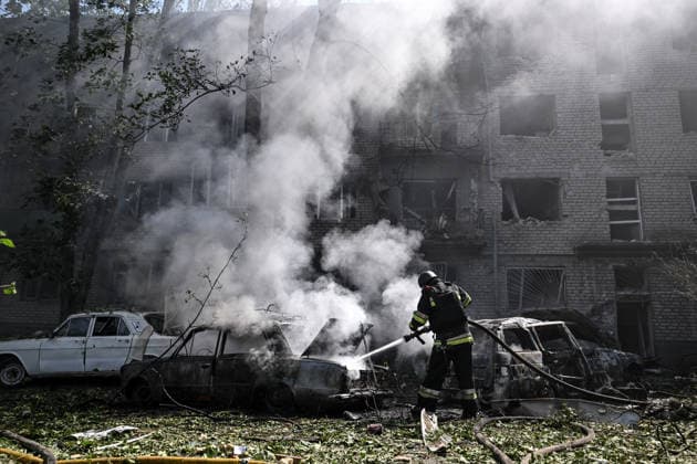A rescuer extinguishes a fire in a car destroyed by a Russian air strike, Zaporizhzhia, Ukraine, August 10, 2026. Russian forces attacked civilian infrastructure in the regional capital and the Zaporizhzhia district with guided aerial bombs. Apartment blocks and private houses were damaged, and cars were wrecked. At least 24 people were injured, including two children. (Photo by Dmytro Smolienko Ukrinform) Russian army attacks Zaporizhzhia with guided bombs again  Copyright: xDmytroxSmolienkox