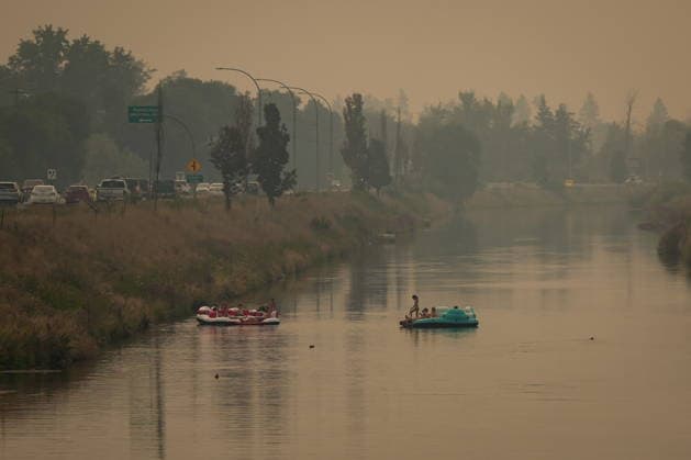 August 10, 2026, Penticton, Bc, CANADA: People float on the Channel Pathway that connects Okanagan Lake and Skaha Lake as smoke from wildfires burning in the region fills the air, in Penticton, B.C., on Monday, Aug. 10, 2026. Penticton CANADA  - ZUMAc35_ 20260810_zaf_c35_028 Copyright: xDarrylxDyckx
