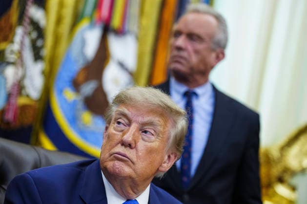 US President Donald Trump prepares to sign an executive order that reevaluates childhood vaccines in the Oval Office of the White House in Washington, DC on August 10, 2026. While the executive order still recommends childhood vaccines for 11 diseases, including measles and polio, it calls for limiting vaccines for other diseases, like hepatitis A and B and meningococcal disease, to high-risk populations.  WAP20260810106 BONNIExCASH