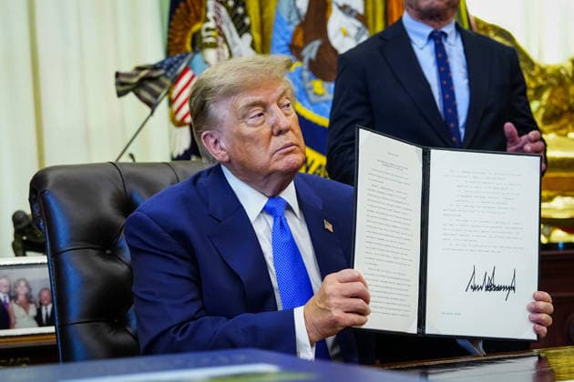 President Donald Trump holds up an executive order that reevaluates childhood vaccines in the Oval Office of the White House in Washington, DC on August 10, 2026. While the executive order still recommends childhood vaccines for 11 diseases, including measles and polio, it calls for limiting vaccines for other diseases, like hepatitis A and B and meningococcal disease, to high-risk populations.  WAP20260810111 BONNIExCASH