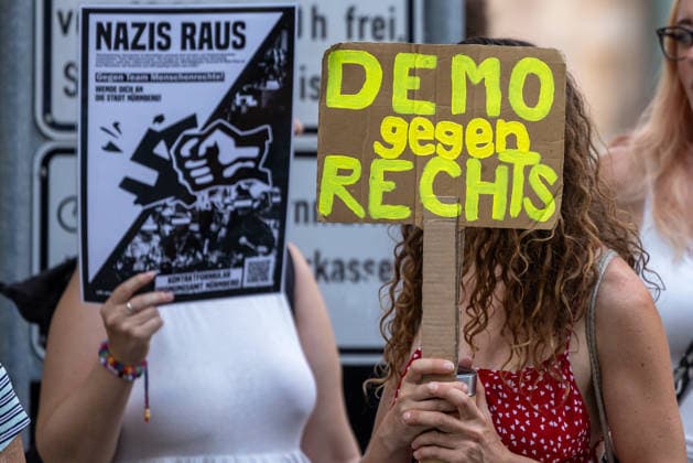 Polizeieinsatz bei Montagsdemo von Team Menschenrechte und Gegenprotesten, Nürnberg, 10.087.2026 Teilnehmerinnen einer Gegendemonstration halten Plakate mit den Aufschriften Nazis raus und Demo gegen Rechts gegen eine Demonstration des Team Menschenrechte. Nürnberg Bayern Deutschland *** Police operation during Monday demonstration by Team Menschenrechte and counter-protests, Nuremberg, August 10, 2026: Participants in a counter-demonstration hold signs reading Nazis Out and Demonstration Against the Far Right in opposition to a demonstration by Team Menschenrechte Nuremberg, Bavaria, Germany 20260810-286A5034-M4000