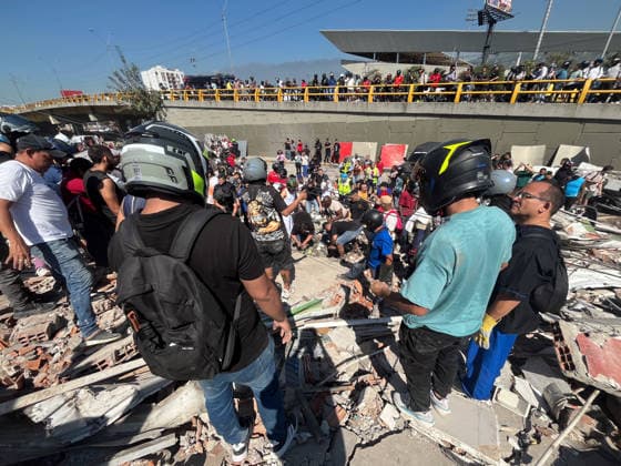 August 10, 2026, Cali, Valle Del Cauca, Colombia: People gather outside rubble of a collapsed building to search for survivors in Cali after a 7,4 Earthquake that struck Colombia on August 10, 2026. Cali Colombia - ZUMAvp1_ 20260810_zia_vp1_009 Copyright: xSebastianxMarmolejox