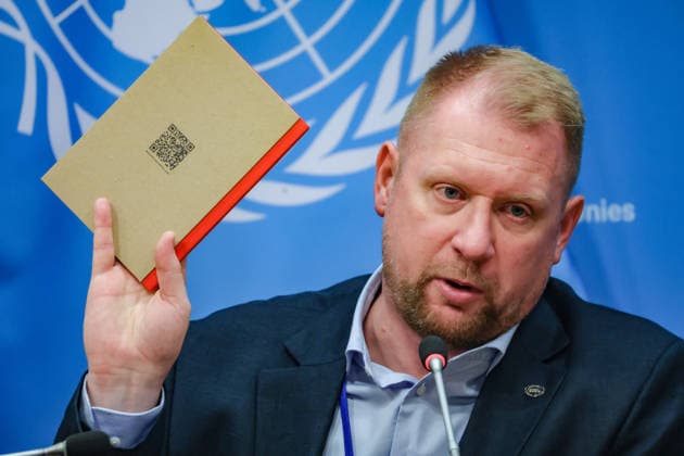 August 10, 2026, New York, New York, United States: OLEG GUSHCHYN, Legal Counsellor with UkraineÃ¢â‚¬â ¢s Coordination Headquarters for the Treatment of Prisoners of War, holds up a publication during a press briefing following the UN Security Council Arria-formula meeting, -Ukrainian Prisoners of War and Civilian Detainees: Testimonies and Accountability,- at UNHQ. The publication compares UkraineÃ¢â‚¬â ¢s stated adherence to the Geneva Conventions in its treatment of Russian prisoners of war with allegations of systematic torture, abuse and other violations of international humanitarian law committed against Ukrainian prisoners of war held in Russian captivity. A QR code directs readers to additional information. New York United States  - ZUMAo116 20260810_znp_o116_056 Copyright: xBiancaxOterox