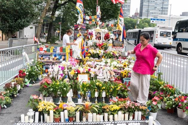 August 10, 2026, New York, New York, USA: A woman tending flowers at memorial as activists continue protesting against treatment by Chinese authorities of Tibetan people by suppressing freedom of religion, language, culture and prosecuting those who dear to speak out. Protest is going on across of UN Headquarters in New York, NY as seen on August 10, 2026 where Lobga Rangzen aka Lobsang Palden, 52, Tibetan activist from New York died after self-immolating on July 2, 2026 and memorial for him is set. His protest came one day after China s Ethnic Unity and Progress Law took effect in what Mandarin language declared as single state-defined banning Tibetan and Uyghur languages being taught in schools. New York USA - ZUMAr339 20260810_znp_r339_027 Copyright: xLevxRadinx
