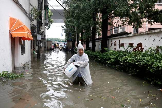 SHANGHAI, CHINA - AUGUST 10: Residents wade through waterlogged areas on August 10, 2026 in Shanghai, China. Typhoon Dolphin that is yet to land already sent downpours to Shanghai on Sunday, flooding low-lying areas and disrupting air and rail travel across eastern China.  Copyright: xChinaxNewsxServicex 111659171233