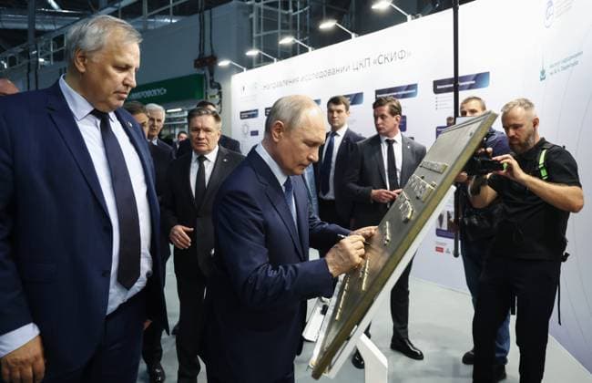 Russia Putin Siberian Federal District 9220615 11.08.2026 Russian President Vladimir Putin signs an autograph as he visits the Siberian Ring Photon Source (SKIF) synchrotron radiation facility, as Rosatom State Atomic Energy Corporation Director General Alexey Likhachev and Director of the Boreskov Institute of Catalysis Valerii Bukhtiyarov stand nearby, near the Koltsovo science town in Novosibirsk region, Russia. Sergey Fadeichev Sputnik Novosibirsk Russia  Copyright: xSergeyxFadeichevx