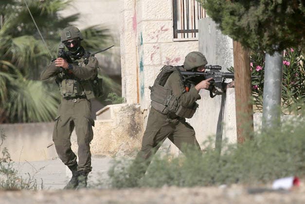 August 11, 2026, Nablus, West Bank, Palestine: Israeli soldiers aim their weapons and take up positions towards Palestinians during the demolition of a home. Israeli army demolished the home of a Palestinian accused of carrying out an armed attack that killed an Israeli soldier and a Jewish settler in the village of Tell. Nablus Palestine  - ZUMAs197 20260811_aaa_s197_004 Copyright: xNasserxishatyehx