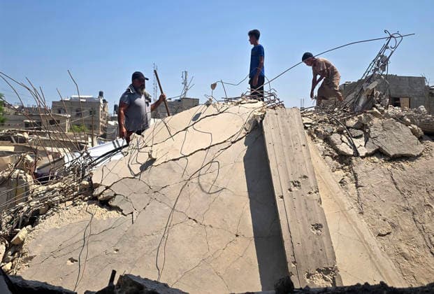 Palestinians Clear Rubble to Return to Destroyed Homes in Khan Younis Palestinians clear rubble from their destroyed homes in Khan Younis refugee camp in the southern Gaza Strip, on August 11, 2026, as they prepare to move their tents to the area amid continued rubble accumulation and delays in debris removal and reconstruction. Families say overcrowding and the spread of insects and rodents in displacement areas have prompted them to try to return to the sites of their destroyed homes. Photo by Tariq Mohammad APA Images Khan Yunis Gaza Strip Palestinian Territory 110826_Khan_Yunis_TM_01(10) Copyright: xapaimagesxTariqxMohammad xapaimagesx