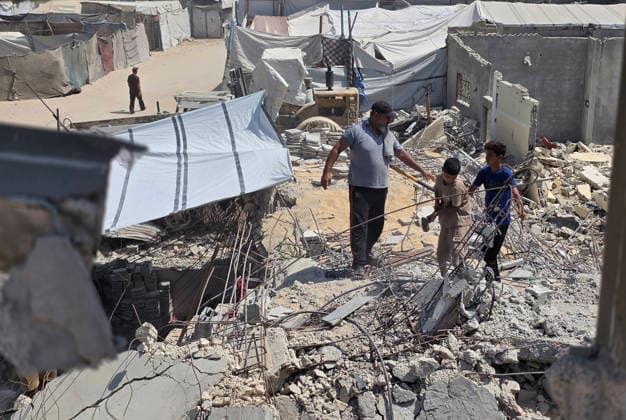 Palestinians Clear Rubble to Return to Destroyed Homes in Khan Younis Palestinians clear rubble from their destroyed homes in Khan Younis refugee camp in the southern Gaza Strip, on August 11, 2026, as they prepare to move their tents to the area amid continued rubble accumulation and delays in debris removal and reconstruction. Families say overcrowding and the spread of insects and rodents in displacement areas have prompted them to try to return to the sites of their destroyed homes. Photo by Tariq Mohammad APA Images Khan Yunis Gaza Strip Palestinian Territory 110826_Khan_Yunis_TM_01(7) Copyright: xapaimagesxTariqxMohammad xapaimagesx