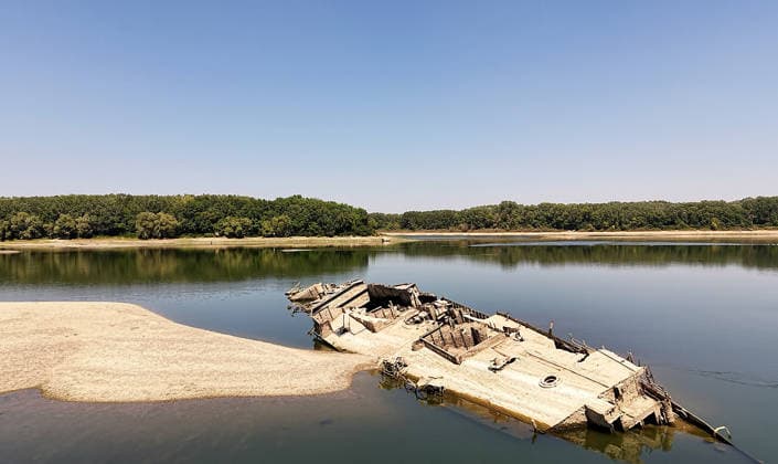 World War II-German warships emerge from Danube amid low water levels in Serbia PRAHOVO, SERBIA - AUGUST 11: Sunken hulls of World War II-era Nazi warships lie exposed in the Danube River near Prahovo, Serbia on August 11, 2026. Extreme heat and severe drought across Europe have caused water levels in the river to drop to historic lows, revealing dozens of scuttled German vessels laden with explosives from 1944. According to some estimates, around 200 World War II shipwrecks lie on the sandy bed of the Danube. Sasa Djordjevic Anadolu Prahovo Serbia. Editorial use only. Please get in touch for any other usage.  Copyright: x2026xAnadoluxSasaxDjordjevicx