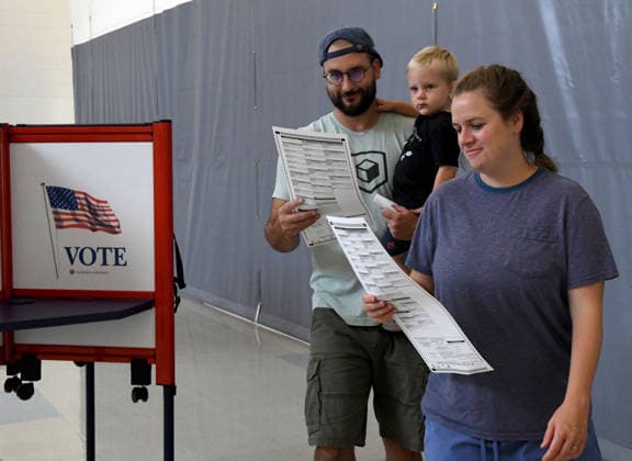August 11, 2026, Racine, Wisconsin, USA: ALEXANDRIA and TYLER SCHEER, with their son CALLAHAN, 2, vote at Fratt Elementary School in Racine in the Wisconsin primary election Tuesday August 11, 2026. National focus is on the Democratic gubernatorial primary and on efforts to flip several Republican congressional seats, including that of incumbent Bryan Steil who represents the First Congressional District, including Racine County. Racine USA  - ZUMAh154 20260811_znp_h154_012 Copyright: xMarkxHertzbergx