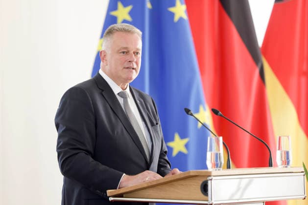 Ministerpräsident Gordon Schnieder am Rednerpult vor Fahnen anlässlich einer Feierstunde zur Verleihung von berufsbezogener Titel in der Staatskanzlei Rheinland-Pfalz 11.08.26 *** Prime Minister Gordon Schnieder at the lectern in front of flags during a ceremony to confer professional titles at the State Chancellery of Rhineland-Palatinate, August 26, 2011