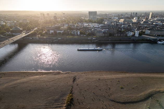 Drought pushes Rhine River to record-low water levels in Germany DUSSELDORF, GERMANY - AUGUST 11: An aerial view of a ship sailing past the partially dried-up riverbed of the Rhine River in Dusseldorf, Germany, on August 11, 2026. Water levels along the Rhine have reached record lows at measuring points across Germany due to ongoing drought and hot weather. The Rhine is a crucial shipping route for the region, and the transport of heavy cargo has already been severely disrupted. Hesham Elsherif Anadolu Dusseldorf Germany. Editorial use only. Please get in touch for any other usage.  Copyright: x2026xAnadoluxHeshamxElsherifx