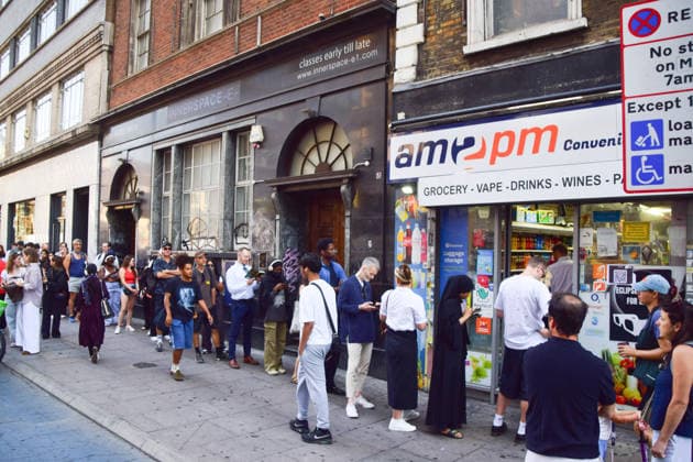 August 12, 2026, London, England, United Kingdom: A long queue forms outside the AM2PM convenience store on Whitechapel High Street in London as people try to snag last-minute solar eclipse glasses ahead of the partial eclipse this evening. London United Kingdom  - ZUMAv130 20260812_zip_v130_013 Copyright: xVukxValcicx