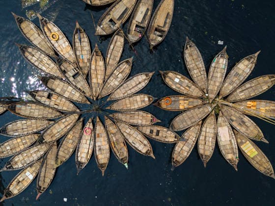 August 12, 2026, Dhaka, Dhaka, Bangladesh: Aerial view of numerous wooden boats clustered together on the Buriganga River in Dhaka, Bangladesh.The boats are ready to transport workers from the outskirts of the city to their jobs in the centre. The Buriganga River is used as a route into the densely populated Bangladeshi capital by millions of workers every day. Dhaka Bangladesh - ZUMAs231 20260812_zip_s231_011 Copyright: xJoyxSahax