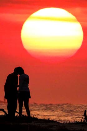 August 12, 2026, Isle Of Palms, Sc, United States: A couple stop for a romantic moment silhouetted by the sunrise, as the massive ball rises over the Atlantic Ocean, August 12, 2026 in Isle of Palms, South Carolina. The Charleston area is currently under a heat advisory with temperatures in the 90Ã¢â‚¬â ¢s and a heat index of 115-degrees. Isle Of Palms United States - ZUMAe02_ 20260812_zaf_e02_006 Copyright: xRichardxEllisx