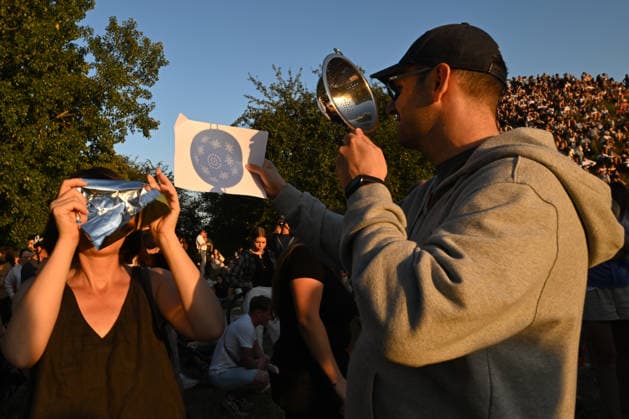 Hundreds Gather At Krakow s Historic Krakus Mound To Watch Solar Eclipse KRAKOW, POLAND - AUGUST 12: A man uses a kitchen colander as a makeshift pinhole projector to cast patterns of the solar eclipse onto a sheet of paper to watch a solar eclipse on August 12, 2026 in Krakow, Poland. Hundreds of residents and tourists ascended the historic prehistoric mound, which offers panoramic views of the city, equipped with protective eyewear and telescopes to witness the rare celestial event. Krakow Poland  Copyright: xArturxWidakx originalFilename: widak-hundreds260812_np0I4.jpg