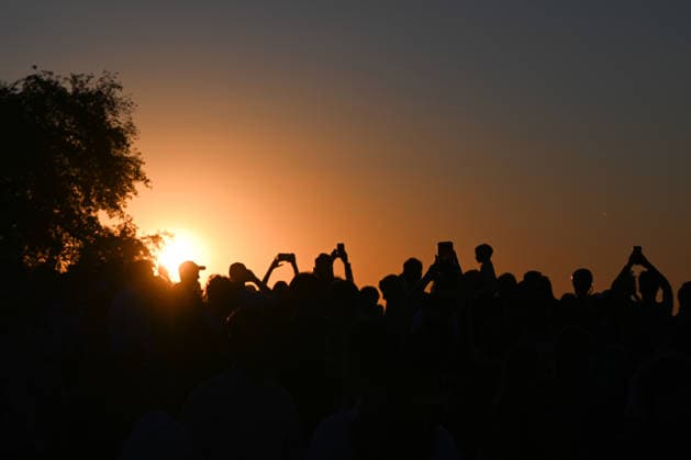 Hundreds Gather At Krakow s Historic Krakus Mound To Watch Solar Eclipse KRAKOW, POLAND - AUGUST 12: Spectators hold up smartphones to capture photos and videos as the sun sinks low on the horizon during a solar eclipse, on August 12, 2026 in Krakow, Poland. Hundreds of people gathered at the summit of the historic Krakus Mound (Kopiec Krakusa) to document the rare celestial event during the late afternoon sunset over Krakow. Krakow Poland  Copyright: xArturxWidakx originalFilename: widak-hundreds260812_nprAk.jpg